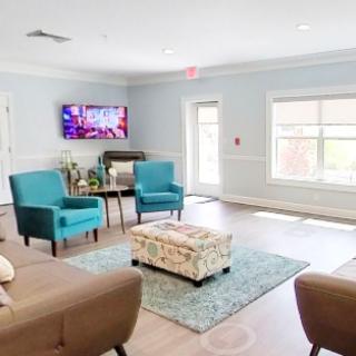 A cozy living room with comfortable seating, a television, and plenty of natural light.