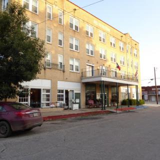 A charming brick hotel illuminated by the warm glow of sunset.