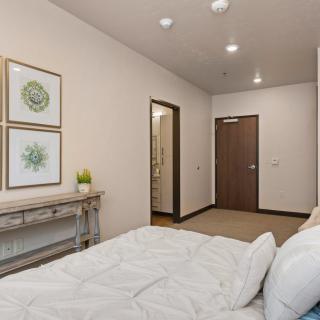 A modern, minimalist bedroom with simple decor and neutral tones.