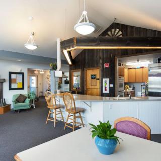 A cozy, modern kitchen and living area with seating and vibrant decor.