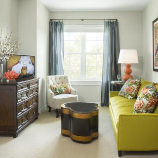 A cozy living room with a lime green sofa and stylish decor.