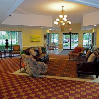 A spacious lobby with comfortable seating and decorative lighting.
