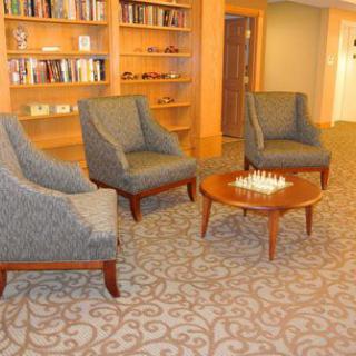 Cozy reading area with armchairs and bookshelves.