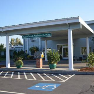 Entrance of a medical facility with an accessible parking spot in front.