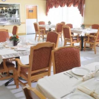 An empty dining room with neatly set tables and chairs.