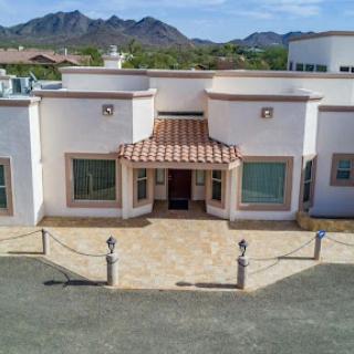 A beautiful modern house with a tiled roof and stunning mountain views.