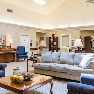 A spacious and well-decorated living room with comfortable seating and elegant lighting.