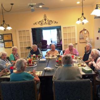 A group of seniors enjoying a meal together in a cozy dining room.