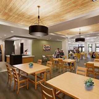 A modern dining area with wooden tables and chairs, featuring contemporary lighting and decor.