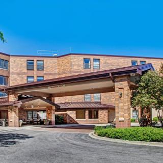 Front entrance of a modern hotel building with a covered driveway.