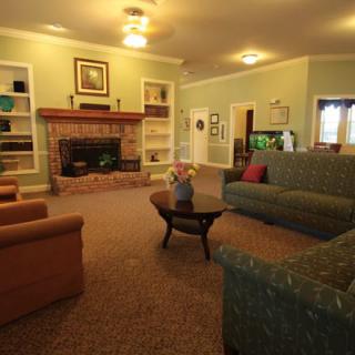 A cozy living room featuring a fireplace, comfortable sofas, and warm lighting.