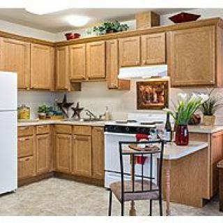 A cozy kitchen with wooden cabinets and modern appliances.