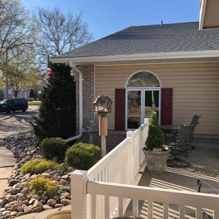 A cozy house with a well-maintained garden and a sunny patio area.