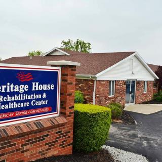 The exterior of Heritage House Rehabilitation & Healthcare Center featuring a brick facade and a welcoming sign.