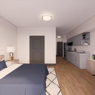 A modern and minimalist bedroom with a kitchenette, featuring elegant furnishings and warm lighting.