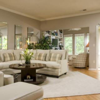 A cozy living room with a sectional sofa and ample natural light.