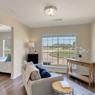 A cozy living area with a large window offering scenic views and ample natural light.