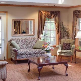 A cozy living room with elegant furniture and warm decor.