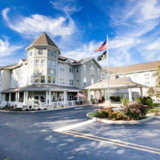 A charming hotel with a distinctive architectural style under a bright blue sky.