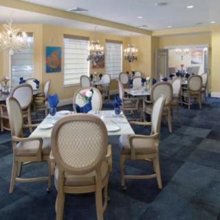 An elegant dining room with neatly set tables and classic decor.