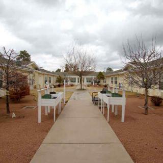 A peaceful courtyard with tables and chairs on a cloudy day.