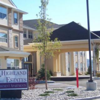Entrance view of Highland Estates with visible signage and landscaping.