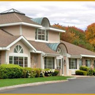A suburban house surrounded by autumn foliage.