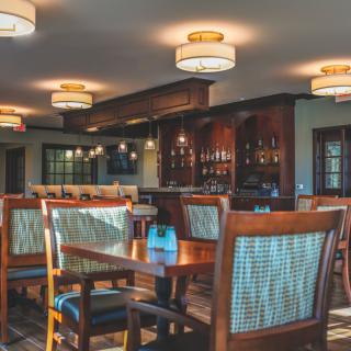 A cozy restaurant interior with wooden furniture and ambient lighting.