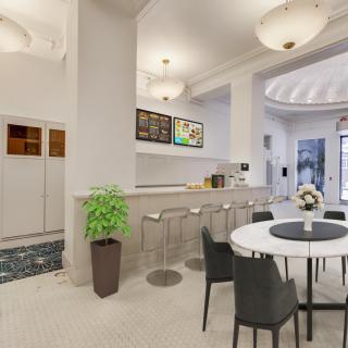 A modern kitchenette with bar seating and a cozy dining area.