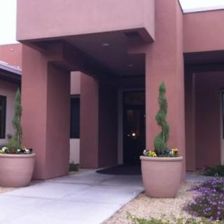 Modern building entrance with potted plants.