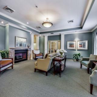 A well-appointed living room with a fireplace, comfortable seating, and tasteful decor.