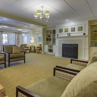 A cozy living room with comfortable seating, a fireplace, and elegant decor.
