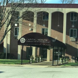 Exterior view of a healthcare facility showing the entrance and signage.