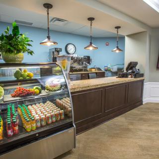Modern cafe interior with a food and beverage display counter.