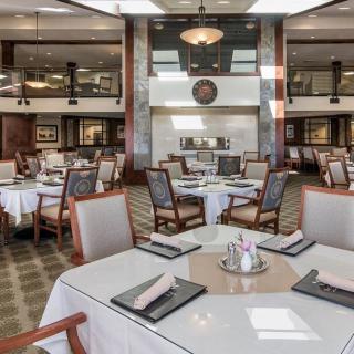 An elegant restaurant dining area with neatly arranged tables and chairs.