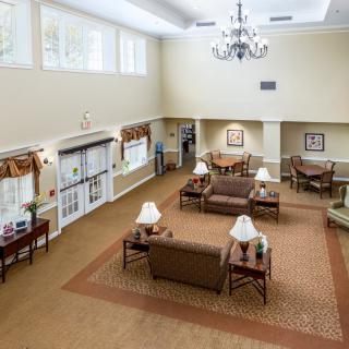 A spacious lobby area with comfortable seating and a large chandelier.