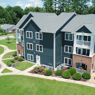 A modern apartment complex surrounded by well-maintained landscaping.