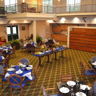 An elegant indoor dining area with tables and chairs arranged for guests.
