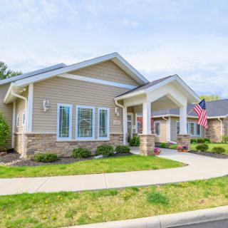 A charming suburban home with a well-maintained front yard and an American flag proudly displayed.