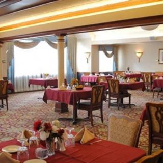 An elegant restaurant dining area with neatly arranged tables and chairs.