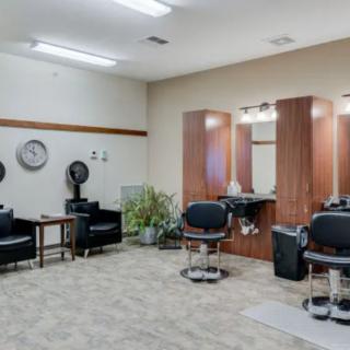 Modern hair salon with styling stations and a waiting area.
