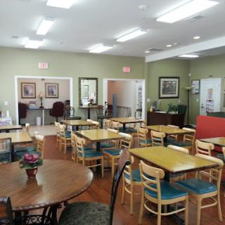 A spacious dining room with wooden tables and chairs, creating a welcoming atmosphere.