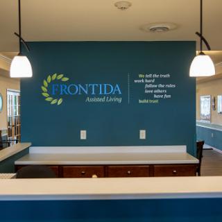 The welcoming reception area of Frontida Assisted Living, showcasing modern design and a calming blue color scheme.