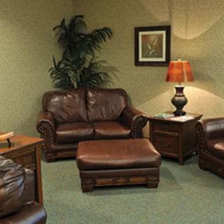 A cozy living room with leather furniture and warm lighting.