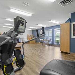 A view of a fitness area featuring exercise equipment, designed for rehabilitation and wellness.
