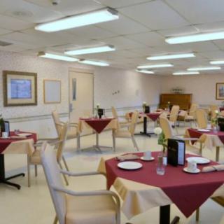 An empty dining room with tables set for service.