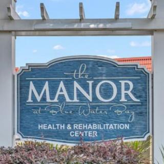 A sign for The Manor Health & Rehabilitation Center.