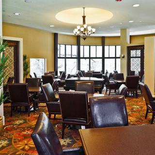 Spacious dining room with elegant furniture and large windows.
