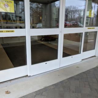 The entrance of a shopping center featuring automated glass doors.