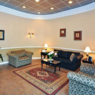 A cozy living room with comfortable seating and warm lighting.